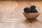 Fresh blackberries in wood bowl on wooden table with paper card