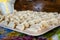 Fresh blinded dumplings lie in rows on wooden board. hand sculpting dumplings