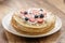 Fresh blinis or crepes with fresh berries and cream