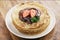 Fresh blinis or crepes with melted dark chocolate and berries
