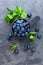 Fresh Blueberries in a bowl on dark background, top view. Juicy wild forest berries, bilberries