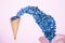 Fresh blueberries in ice cream cone on a pink background. Blueberry Blast. Summer vacation concept. Flat lay, top view. The style