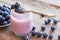 Fresh blueberries yogurt in glass jar, spoon and saucer