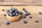 fresh blueberry in a wood bowl on the wooden table