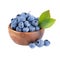 Fresh blueberry in wooden bowl with green leaves, isolated on white background. Bilberry or whortleberry. Clipping path.