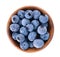 Fresh blueberry in wooden bowl, isolated on white background. Bilberry or whortleberry. Clipping path. Top view.