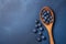 Fresh blueberry on wooden spoon. Flat lay, top view