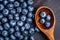 Fresh blueberry on wooden spoon. Flat lay, top view