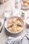 Fresh boiled dumplings in a light plate on a light background.