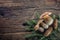 Fresh boletus edulis mushrooms with spruce bunch and cones on rustic woden table