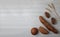 Fresh bread - buns, baguette and ears of wheat on wooden background flat lay