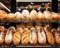 fresh bread buns and baguettes on supermarket bakery shelves.