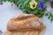 Fresh bread loaf and viola tricolor flowers