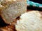 Fresh bread from the oven, halved, on a wooden cutting board, close-up photo