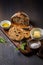 Fresh bread slice with sage butter, olive oil and salt on rustic table on cutting board