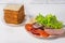 Fresh bread slices, vegetables, cheese and ham are prepared for sandwiches. Fast food preparation concept