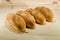 Fresh bread on the wooden table background. Bakery concept. bunch of loafs laying in line.