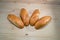 Fresh bread on the wooden table background. Bakery concept. bunch of loafs laying in line.