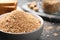 Fresh breadcrumbs in bowl on black table, closeup