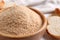 Fresh breadcrumbs in bowl on table, closeup