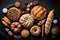 Fresh breads, pastries, buns and sweet rolls on black background, top view, flat lay