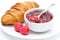 Fresh breakfast - raspberry jam and croissant on a plate