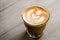Fresh brewed coffee in tumbler glass with beautiful latte art
