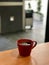 Fresh Brewed Steaming Filter Coffee in Red Cup at Cafe Shop