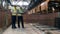 Fresh bricks are moving along the belt and two industrial engineers, workers are observing it