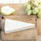 Fresh Brie Cheese on cutting board with grapes and fruits, top