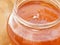 Fresh bright amber color honey with bubbles in jar. The texture of the honey. Healthy food concept