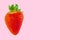 Fresh bright strawberry isolated on pink pastel background