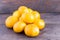 Fresh bright tangerines on dark wooden background