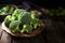 Fresh broccoli in bowl on wooden table