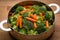 Fresh broccoli and carrots in stainless steel colander