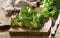 Fresh broccoli florets on a wooden table