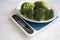 Fresh broccoli kitchen scale  concept organic gourmet health  on a light background