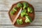 Fresh broccoli with knife on wooden board