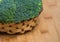 Fresh broccoli solated in basket on wooden background