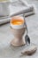 Fresh broken soft boiled egg on a stand up on white concrete rustic background. Soft eggs, healthy breakfast
