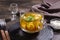 Fresh broth with dumplings in glass bowl on table