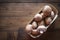 Fresh brown champignons in the small package on the wooden background