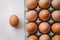 Fresh brown eggs on tray, against white background, evoke thoughts of farm produce.