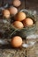 Fresh brown eggs on wood background