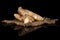 Fresh brown ginger isolated on black glass