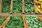 Fresh Brussel sprouts, green peas, yellow squash patty pan patisson piled in the baskets on the market. Food background