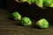 Fresh Brussels sprouts on a brown wooden background.