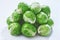 Fresh Bruxelles sprouts on white background closeup.