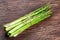 Fresh bunch asparagus on wooden table background