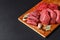 Fresh butcher cut meat assortment on black background